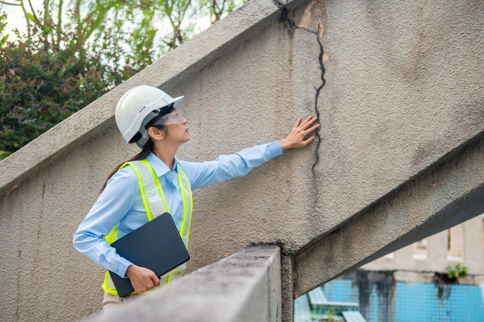 Engineer checking a crack in a concrete stair