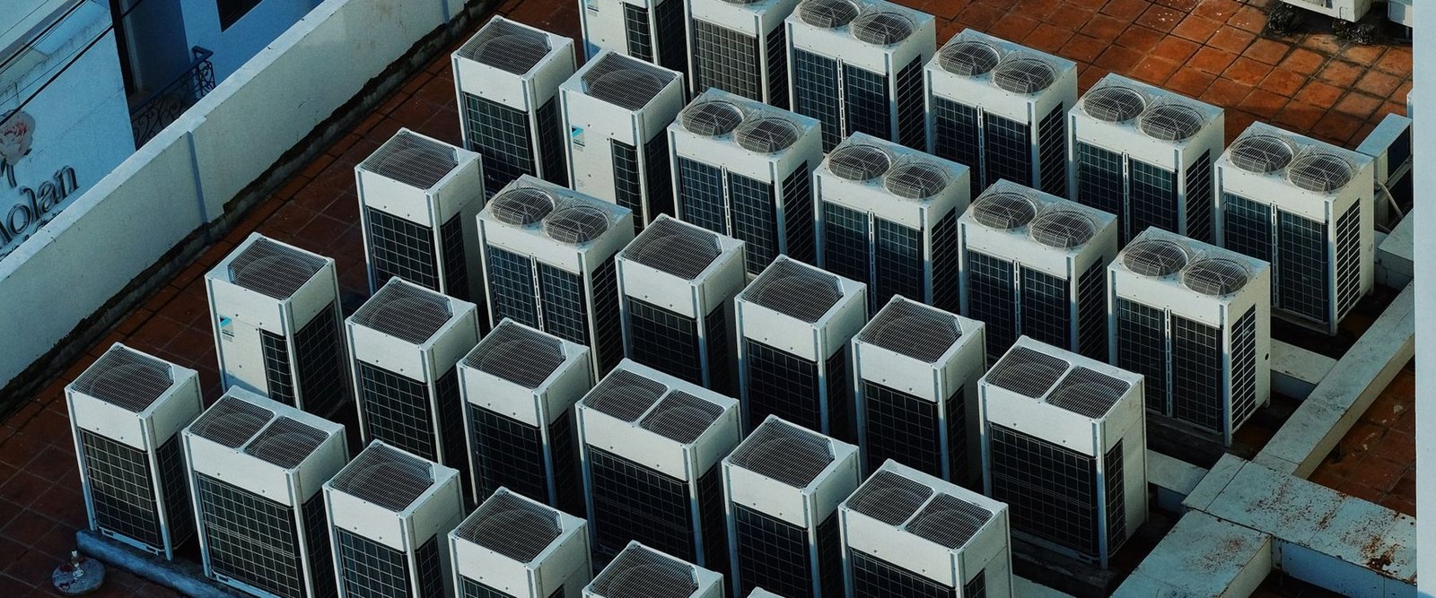 Rows of rooftop mechanical units set on a flat roof